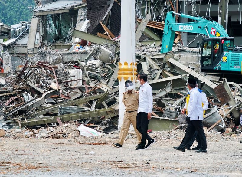 Indonesian President Joko Widodo walks during a visit inspecting the area affected by the earthquake in Mamuju