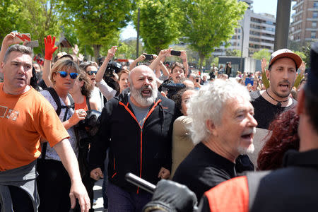 Protesters break through a police line after a nine-year sentence was given to five men accused of the multiple rape of a woman during Pamplona's San Fermin festival in 2016, in Pamplona, Spain, April 26, 2018. REUTERS/Vincent West