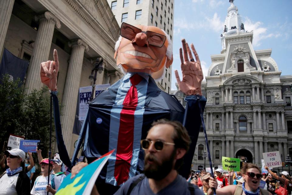 A giant Bernie Sanders puppet is carried as protesters march against presumptive Democratic presidential nominee Hillary Clinton ahead of the DNC. (Photo: Dominick Reuter/Reuters)