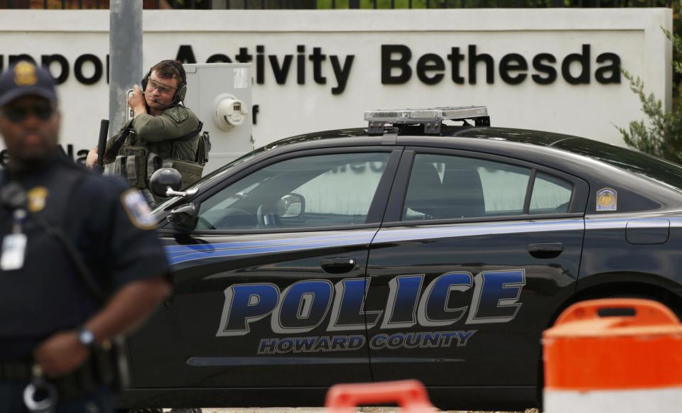 Police SWAT team members and Navy security respond to the entrance to the campus of Walter Reed National Military Medical Center as law enforcement officers investigate a report of a gunshot heard at the U.S. Navy facilty in the Washington suburb of Bethesda, Maryland, July 6, 2015. The Navy said employees at the sprawling hospital's campus in Bethesda, Maryland, were told to shelter in place as police and security personnel responded to an unconfirmed report of an active shooter. REUTERS/Kevin Lamarque