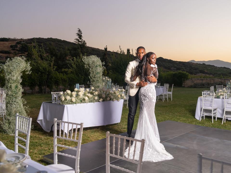 A bride and groom embrace on their wedding day.