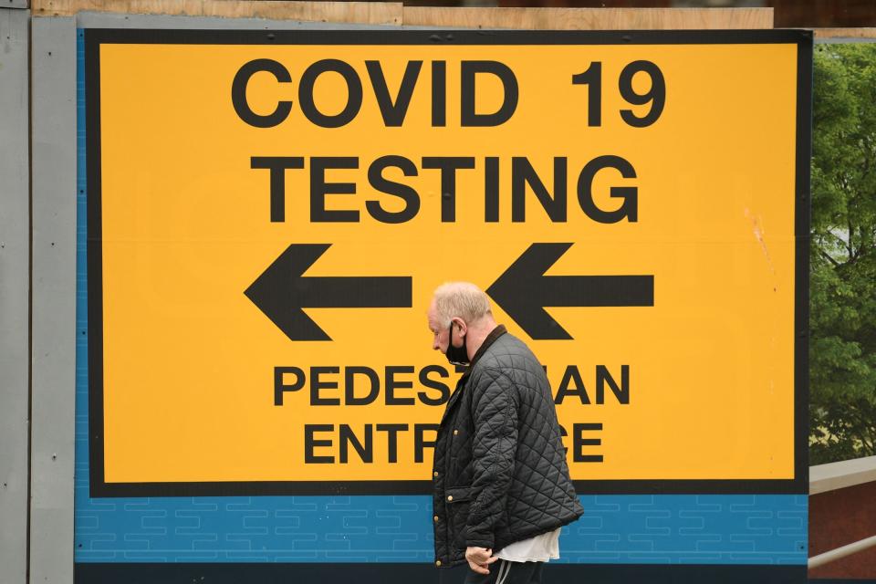 <p>A pedestrian walks past a sign directing members of the public to a Covid-19 testing centre in Bolton, northwest England, on May 28, 2021. - British Prime Minister Boris Johnson said Wednesday that Covid-19 vaccines are proving effective against a variant that has spread like wildfire in India and denied the government was being lax on travel from hotspots. (Photo by Oli SCARFF / AFP) (Photo by OLI SCARFF/AFP via Getty Images)</p>
