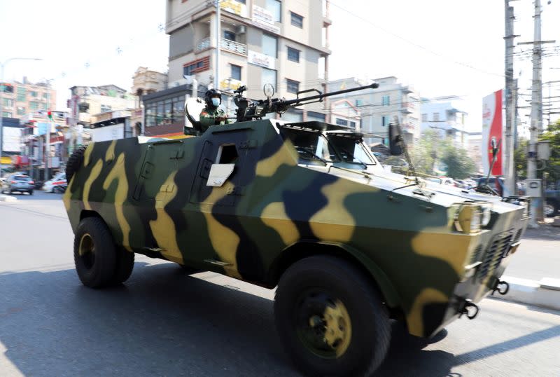 Myanmar Army armored vehicles drive in a street