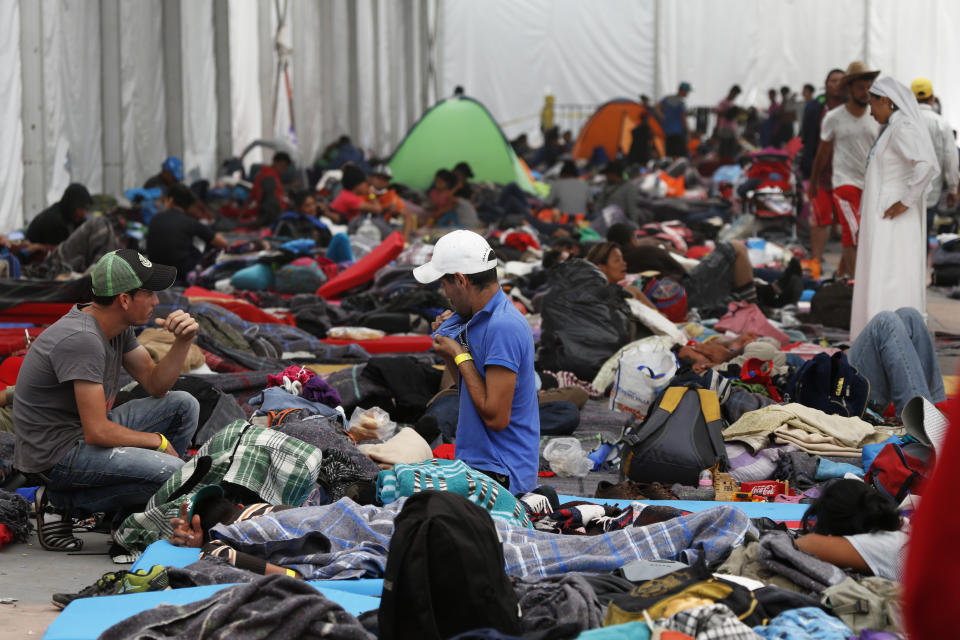 Central American migrants settle in a shelter at the Jesus Martinez stadium in Mexico City, Tuesday, Nov. 6, 2018. Humanitarian aid converged around the stadium in Mexico City where thousands of Central American migrants winding their way toward the United States were resting Tuesday after an arduous trek that has taken them through three countries in three weeks. (AP Photo/Marco Ugarte)