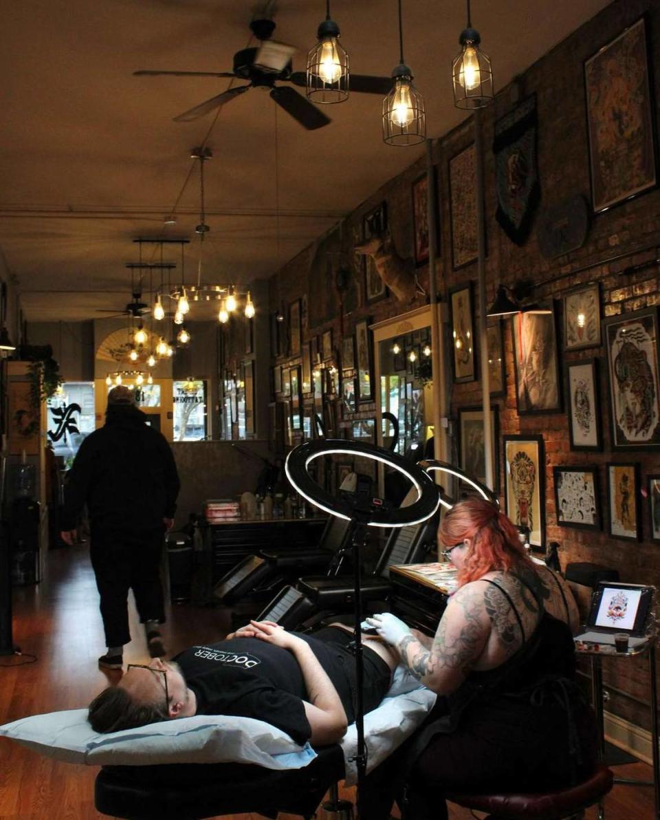 Beeker Wagner works on a customer’s tattoo at X. Tattoo in Bellingham.