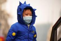 A boy wears a mask at the Nanjing Pedestrian Road, a main shopping area, in Shanghai