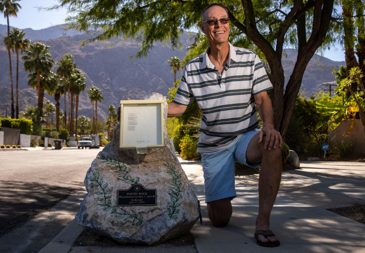 Poet Gary Hunter poses for a photo next to the "Poetry Rock" outside his home in Palm Springs, Calif., on May 12, 2022. Since 2015, Hunter has been writing daily poems and posting them on the rock outside of his home for anyone to read and enjoy.