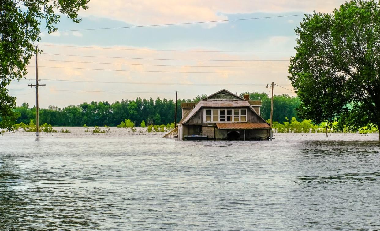 View of old wooden house flooded by Missouri River in spring.