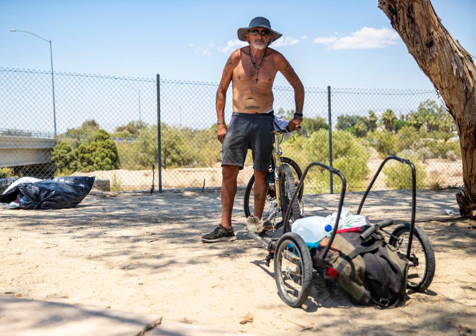 Steve Grant with his bike and some of his belongings along a bike path in Palm Springs on Wednesday.