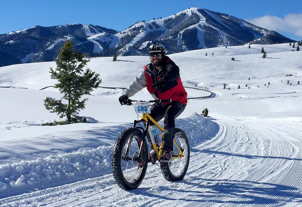 In this Jan. 30, 2016, file photo, a contestant competes in the Snowball Special fat bike race at Sun Valley Resort in Blaine County, Idaho. The county has become the epicenter of Idaho's outbreak.