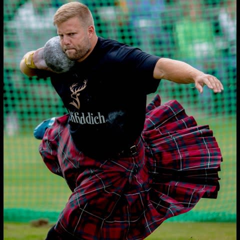 A competitor takes part in the Putting the Heavy Stone competition at the Braemar Gathering - Credit: Andrew Parsons / i-Images 
