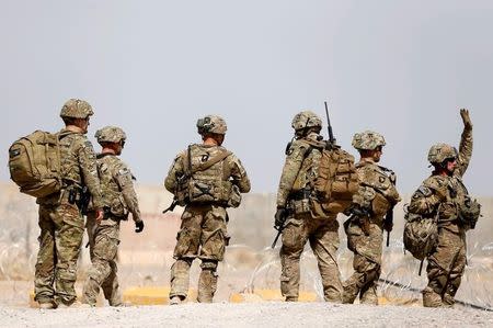 FILE PHOTO: U.S. troops walk outside their base in Uruzgan province, Afghanistan July 7, 2017. REUTERS/Omar Sobhani/File Photo