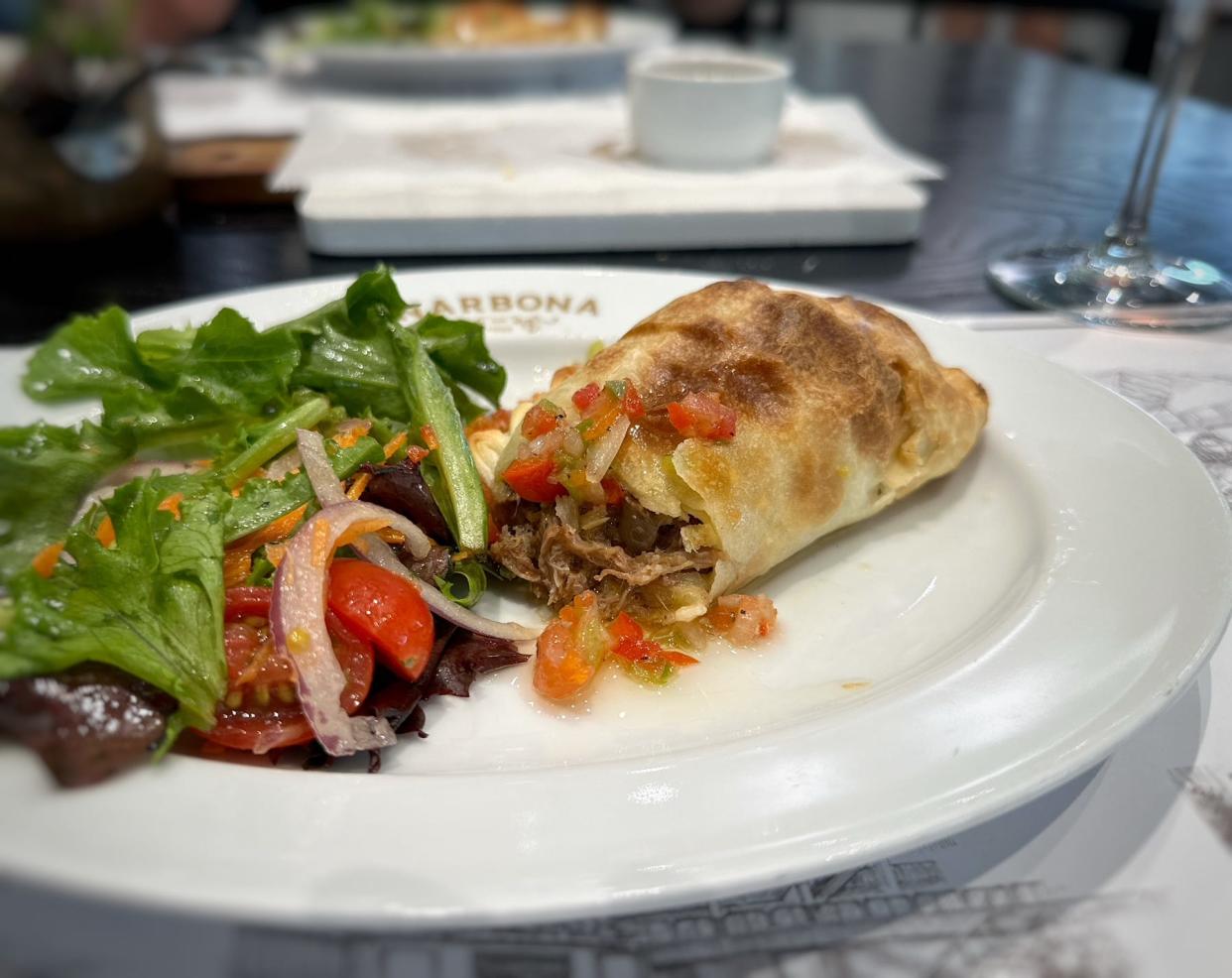 The short rib empanadas at Narbona market/café in Boca Raton are stuffed with juicy pulled beef short rib meat and served with classic Uruguayan salsa criolla.