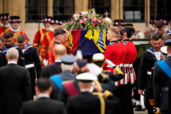 LONDON, ENGLAND - SEPTEMBER 19: The coffin of Queen Elizabeth II with the Imperial State Crown resting on top is carried by the Bearer Party into Westminster Abbey during the State Funeral of Queen Elizabeth II on September 19, 2022 in London, England. Elizabeth Alexandra Mary Windsor was born in Bruton Street, Mayfair, London on 21 April 1926. She married Prince Philip in 1947 and ascended the throne of the United Kingdom and Commonwealth on 6 February 1952 after the death of her Father, King George VI. Queen Elizabeth II died at Balmoral Castle in Scotland on September 8, 2022, and is succeeded by her eldest son, King Charles III.  (Photo by Christopher Furlong/Getty Images)