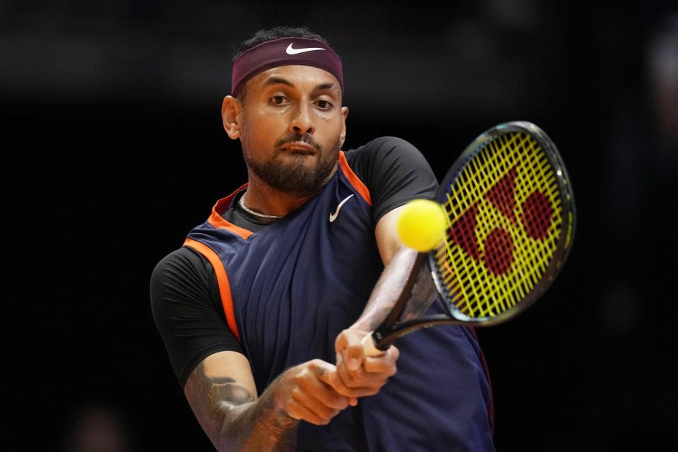 FILE - Nick Kyrgios returns the ball to Grigor Dimitrov during a match of Day 3 of the World Tennis League at Coca-Cola Arena in Dubai, United Arab Emirates, Dec. 21, 2022. Kyrgios is expected to compete at Wimbledon next week. (AP Photo/Kamran Jebreili, File)
