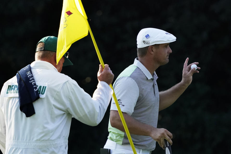 Bryson DeChambeau holds up his ball after a birdie on the sixth hole during the second round of the Masters golf tournament Friday, Nov. 13, 2020, in Augusta, Ga. (AP Photo/Charlie Riedel)