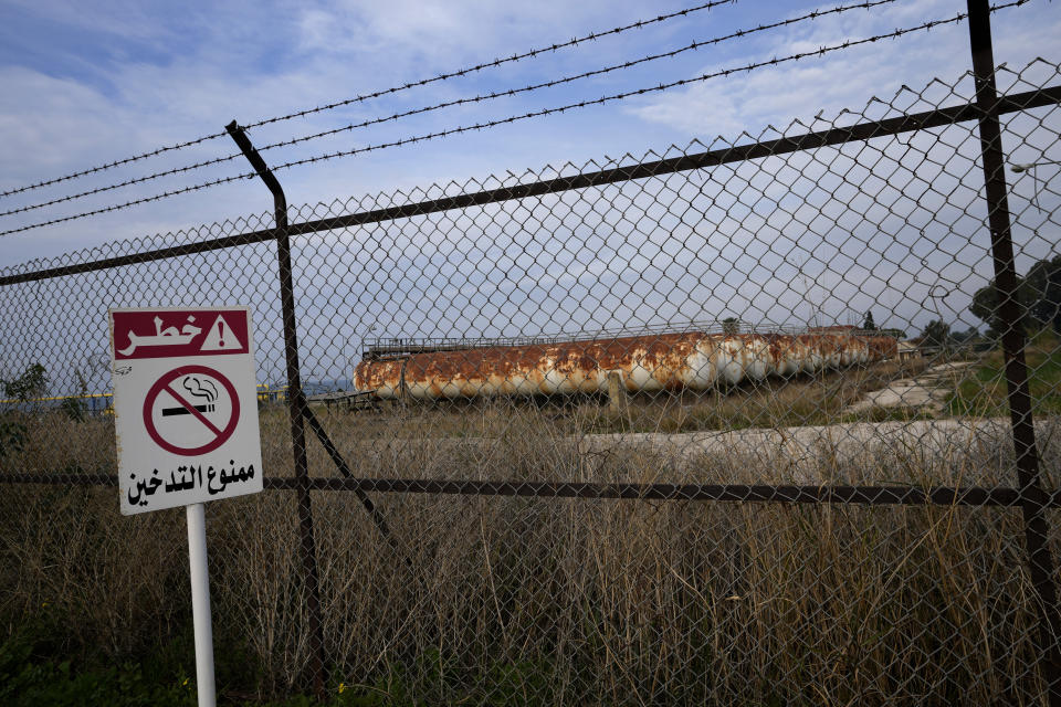 A sign with Arabic that reads, "danger, No smoking," is posted at the Biddawi oil facility in the northern city of Tripoli, Lebanon, Tuesday, Dec. 28, 2021. Lebanese Energy Minister Walid Fayad launched two projects in the country’s north on Tuesday to facilitate the flow of natural gas from Egypt. The move aims to improve electricity production and expand the country’s tanks to increase oil reserves. (AP Photo/Hassan Ammar)