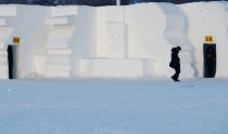 A woman leaves a toilet which has been decorated into a snow sculpture at the Harbin International Snow Sculpture Art Expo in the northern city of Harbin, Heilongjiang province January 5, 2014. The signs read: "Gents" (L) and "Ladies" (R). REUTERS/Kim Kyung-Hoon (CHINA - Tags: SOCIETY ENVIRONMENT TPX IMAGES OF THE DAY)