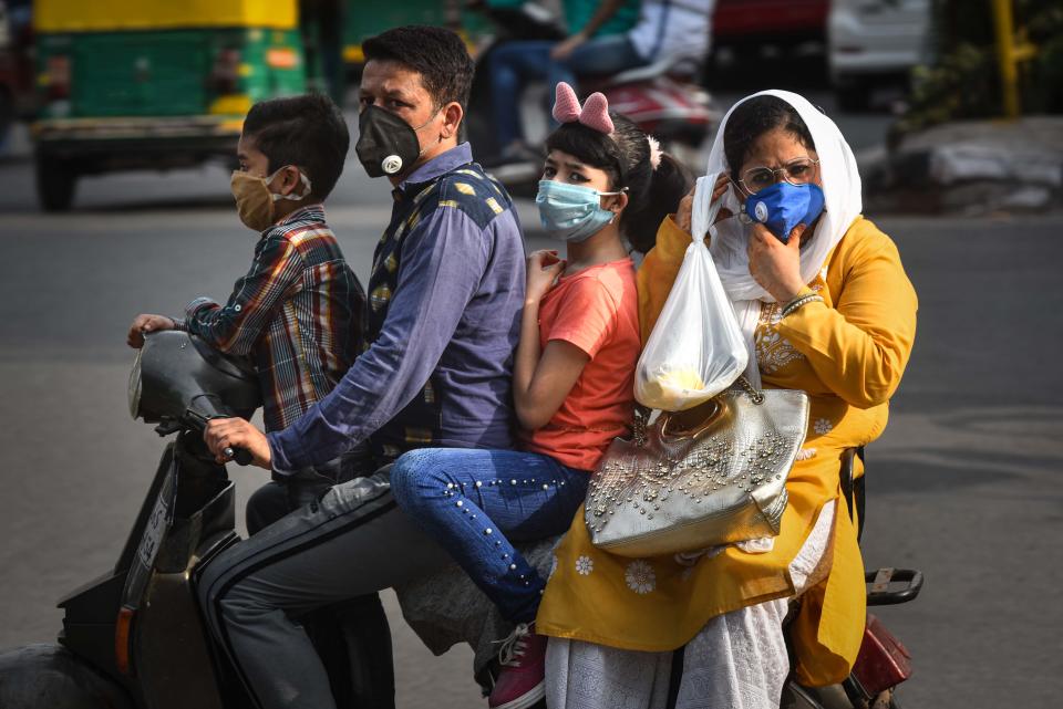 <strong>Just masks won't do, helmets save lives too.</strong> (Photo by Sanchit Khanna/Hindustan Times via Getty Images)