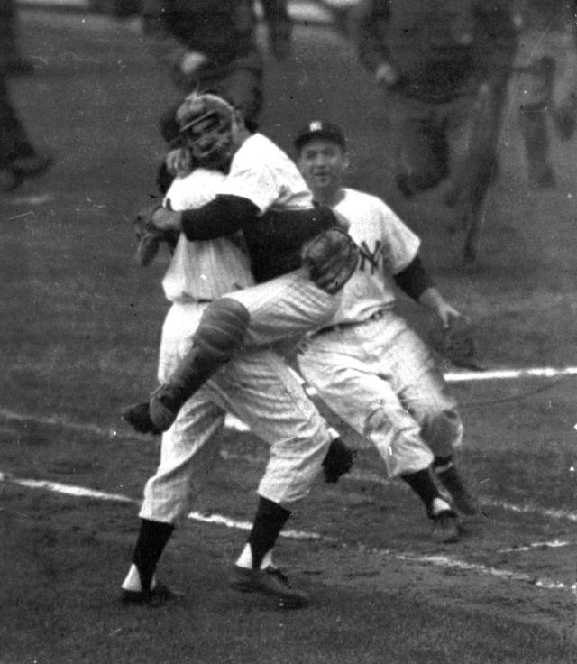 FILE- In this Oct. 8, 1956, file photo, New York Yankees catcher Yogi Berra is embraced by pitcher Don Larsen as he leaps into Larsen's arms at the end of Game 5 of baseball's World Series against the Brooklyn Dodgers at New York's Yankee Stadium. Larsen pitched a perfect game. The jersey worn by Larsen when he pitched the only perfect game in World Series history will soon be available for auction by Steiner Sports Memorabilia who will run the auction October through December 2012. (AP Photo, File)