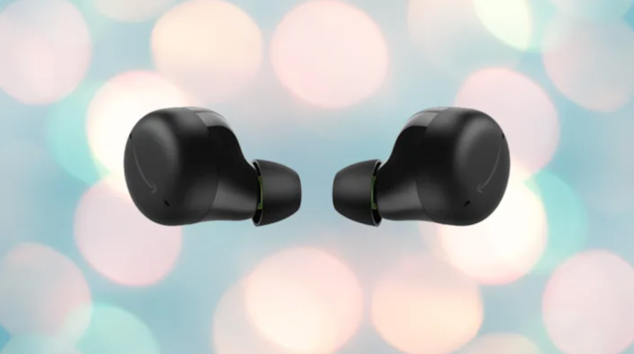 2 small black wireless earbuds against a bokeh background