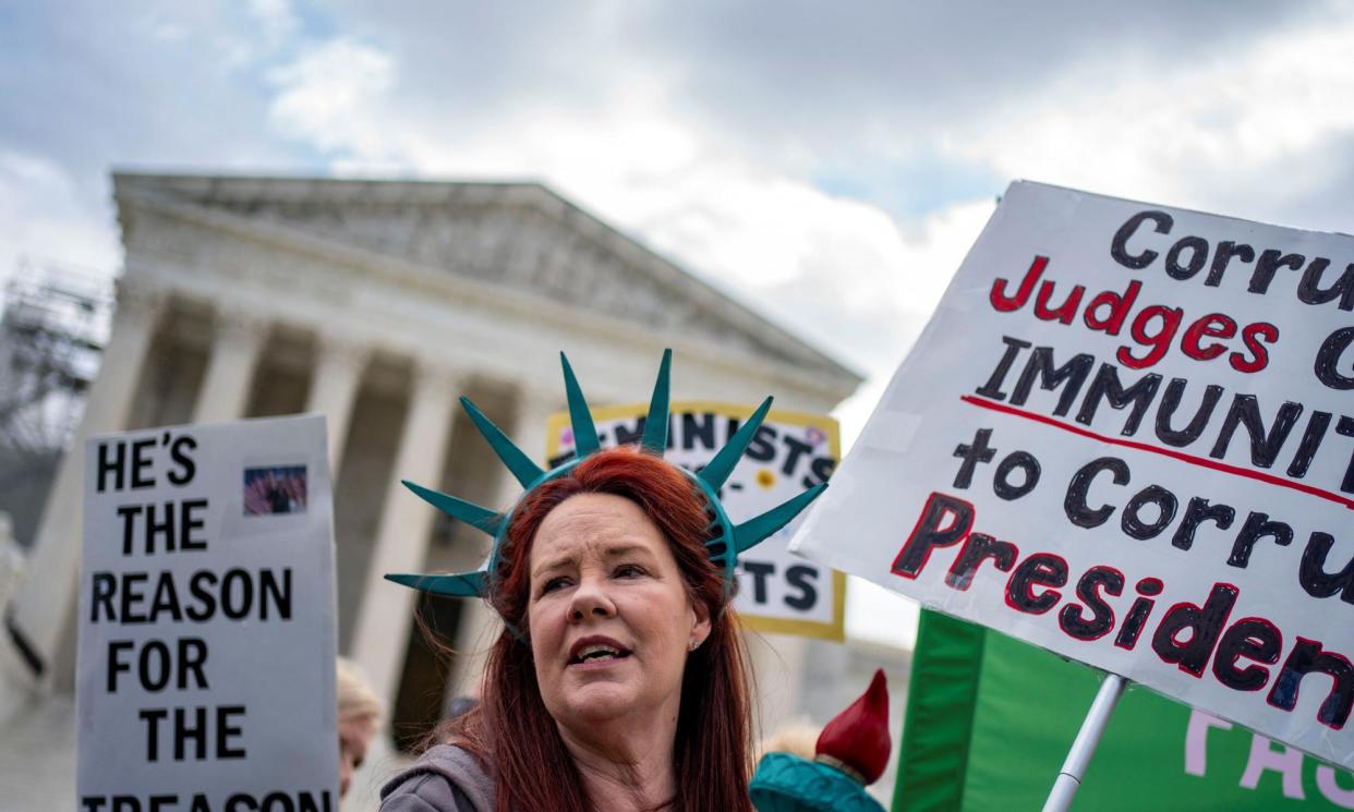 <span>An anti-Trump protester outside the supreme court on Thursday.</span><span>Photograph: Bonnie Cash/Reuters</span>