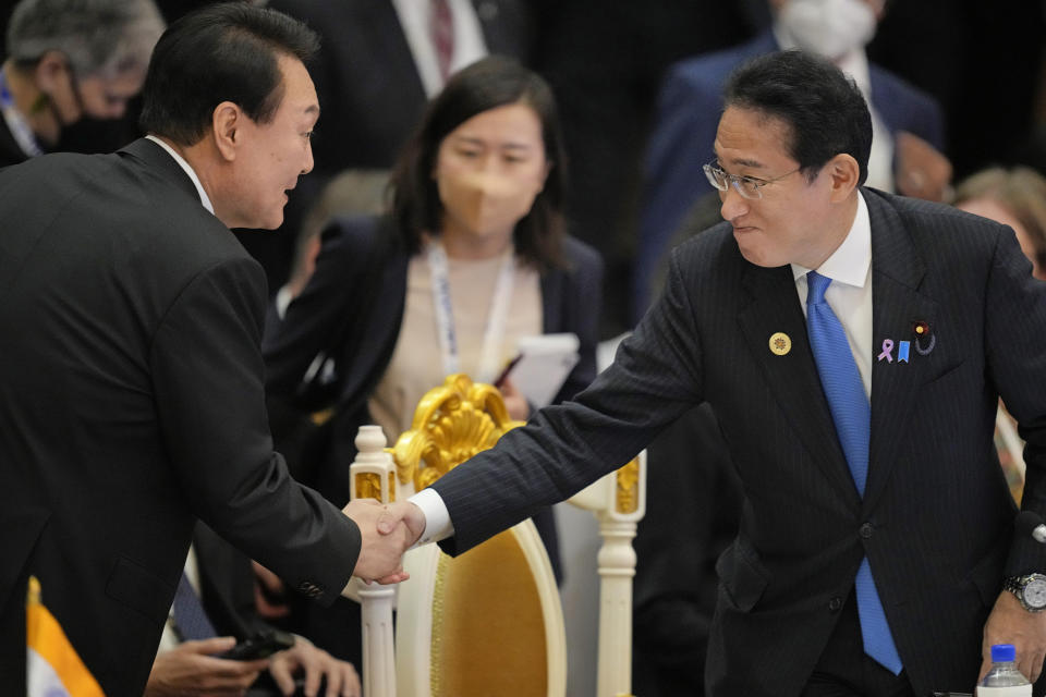 FILE - Japan's Prime Minister Fumio Kishida, right, shakes hands with South Korea's President Yoon Suk Yeol during the ASEAN - East Asia Summit in Phnom Penh, Cambodia, on Nov. 13, 2022. South Korean and Japanese leaders will meet in Tokyo on Thursday, March 16, 2023, beginning their first bilateral summit in more than a decade, and hoping to overcome resentments that date back more than 100 years. (AP Photo/Vincent Thian, File)