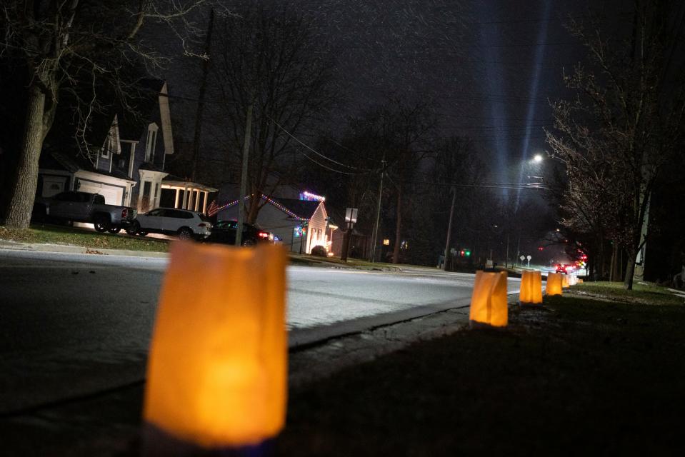 A spotlight with four light streaks illuminates the sky to honor the one-year anniversary of the Oxford High School shooting, where four students were killed, in Oxford on Wednesday, Nov. 30, 2022.