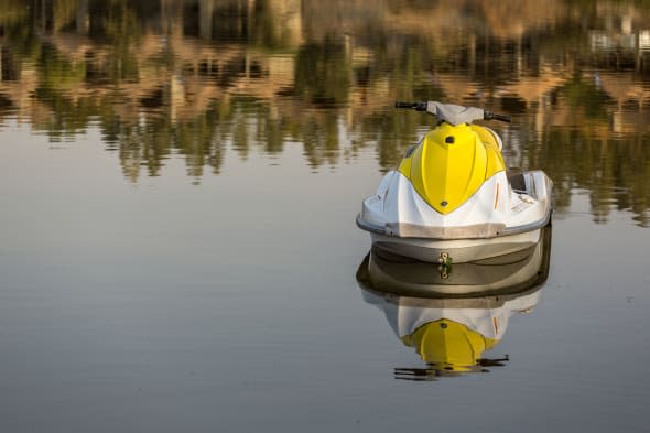 A Jetski parked on the still waters of lake langano