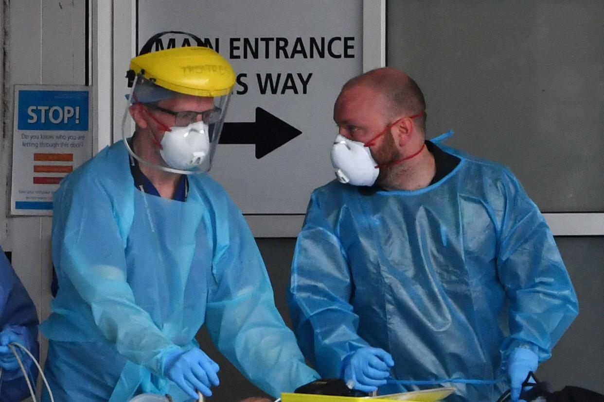 Staff wear personal protective equipment (PPE) as they work at the Royal Liverpool University Hospital in Liverpool, northwest England on April 18, 2020. - Britain's death toll from the coronavirus rose by 847 on Friday, health ministry figures showed, a slightly slower increase than the previous day but still among the worst rates globally. (Photo by Paul ELLIS / AFP) (Photo by PAUL ELLIS/AFP via Getty Images)