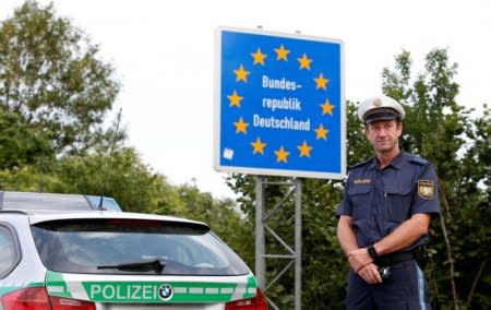 FILE PHOTO: Bavarian Police Officer controls cars at a temporarily checkpoint on the motorway between the Austrian and German border in Kirchdorf am Inn, Germany July 18, 2018.  REUTERS/Michaela Rehle/File Photo