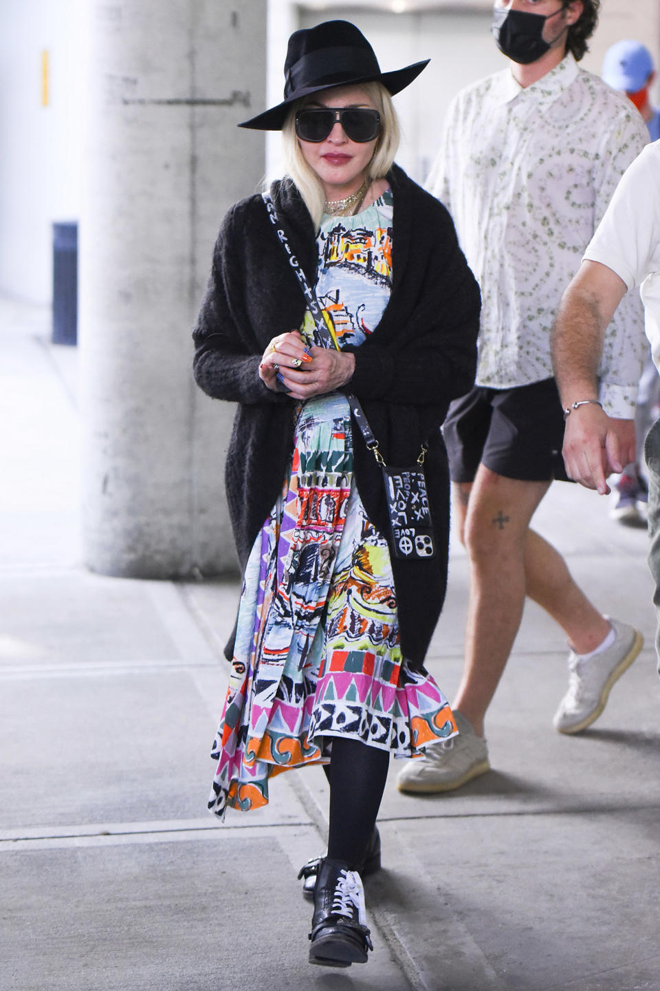 <p>Madonna arrives at JFK Airport in N.Y.C. wearing a colorful dress paired with a black fedora on June 7.</p>