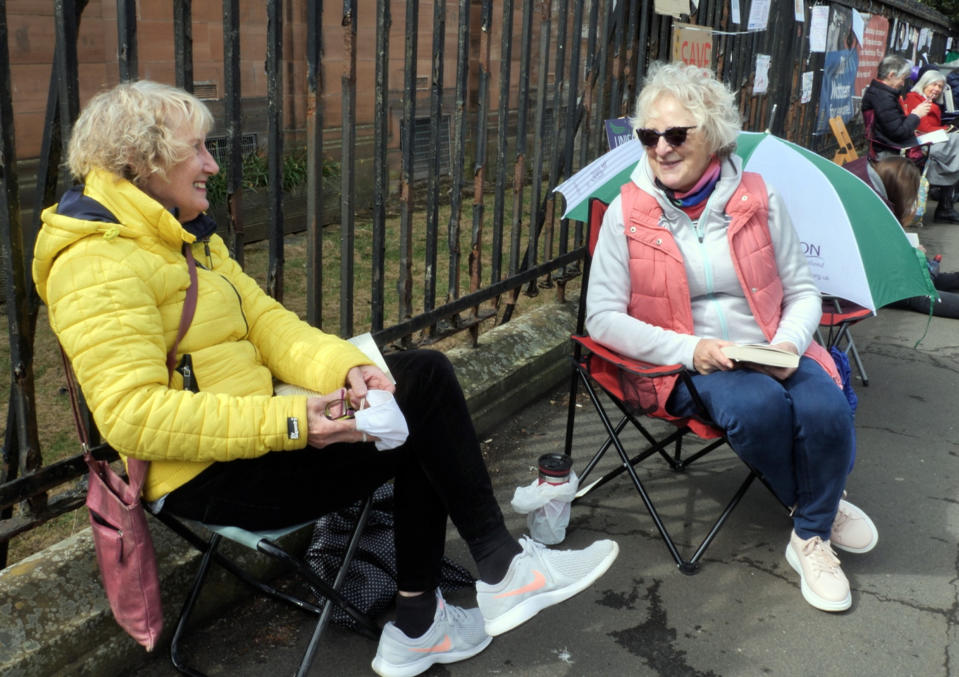 Friends Elizabeth Care, left, who voted against Scottish independence in 2014, and Janet Allan, who voted for it, in Glasgow, Scotland, Saturday, May 1, 2021. Scotland holds an election Thursday that could hasten the breakup of the United Kingdom. The pro-independence Scottish National Party is leading in the polls and a big victory will give it the the moral right and the political momentum to hold a referendum on whether Scotland should end its three-century union with England. But many voters, even if they support independence, are cautious. (AP Photo/Renee Graham)