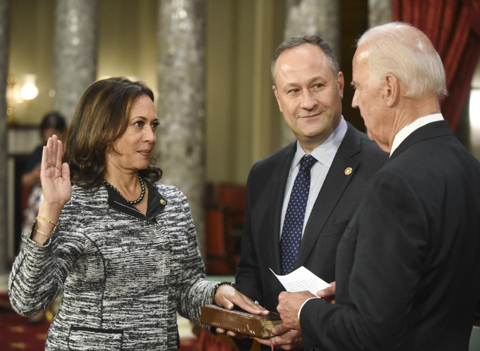 Vice President Biden administers the Senate oath of office to Harris, as her husband, Douglas Emhoff, holds the Bible, on Jan. 3, 2017. (Kevin Wolf/AP)