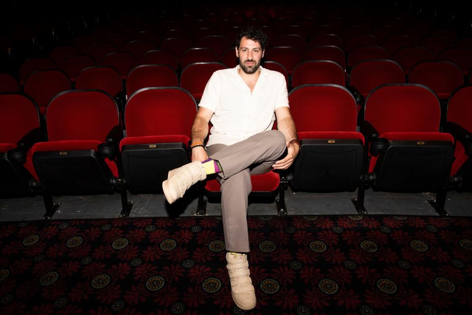 Ali Alsaleh, actor, sits inside the theater at Belcourt Theatre in Nashville , Tenn., Thursday, June 30, 2022. Alsaleh and his family were political refugees who fled Iraq in 2000 and moved to Nashville.