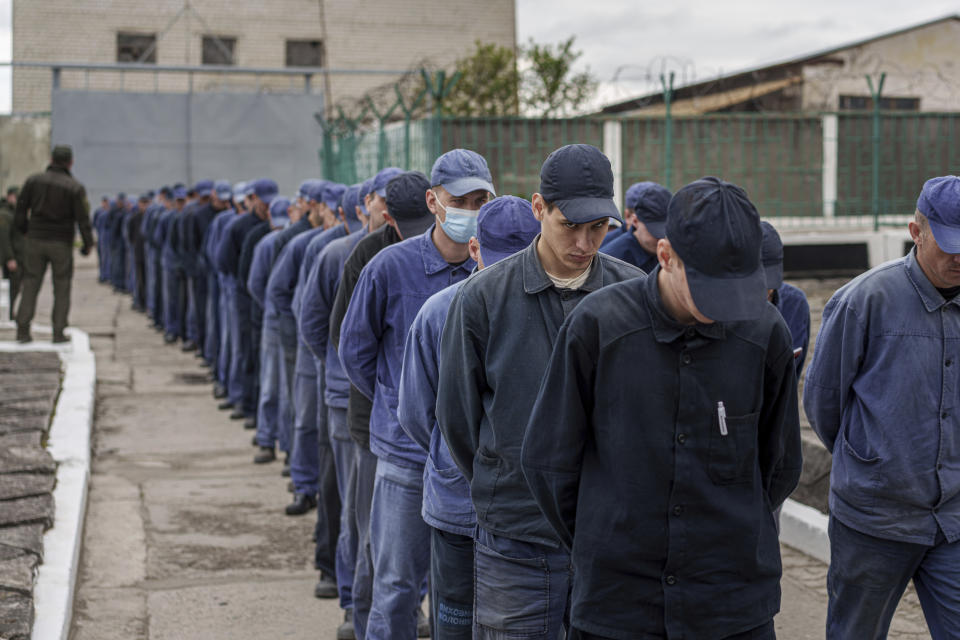 Captured Russian soldiers walk to shelter during an air raid alarm at a prisoner of war detention center in Ukraine's Lviv region, Thursday, April 25, 2024. AP visited the center as part of a small group of journalists on the condition that its exact location be withheld. (AP Photo/Evgeniy Maloletka)