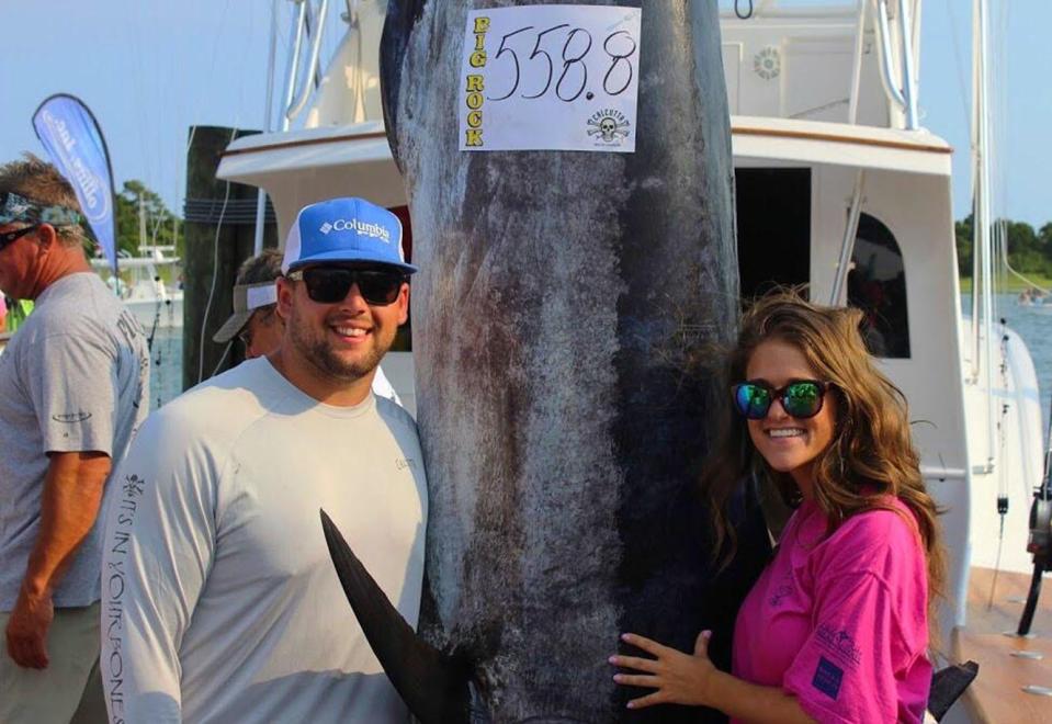 New Big Rock Blue Marlin Tournament director Madison Struyk, stands next to her husband, CJ, after be brought in a 558.8-pound marlin during the 2016 tournament. 