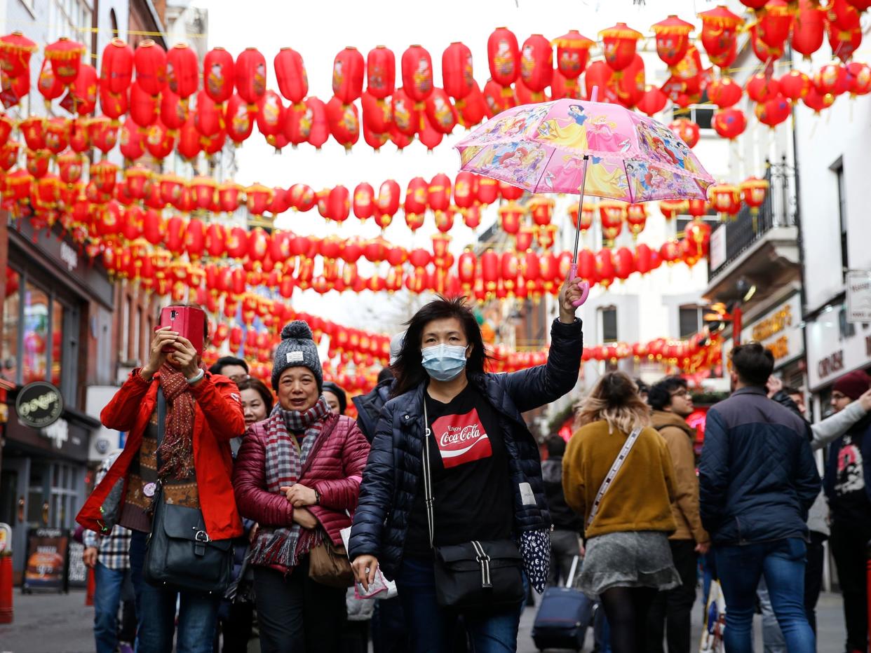 A woman wears a face mask in Chinatown following the rise of global cases: Getty