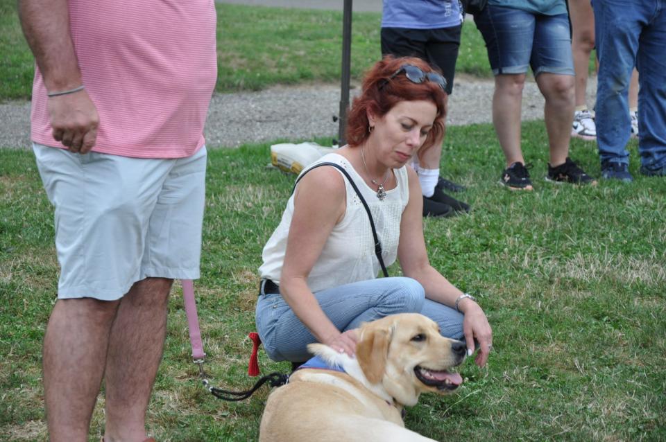 Kim Stout, president of Coastal Pet Products in Alliance, pets Willow, a leader dog Coastal Pet is sponsoring this year for Leader Dogs For the Blind. Stout was at the Greater Alliance Carnation Festival Pet Show at the Jaycee Shelter in Silver Park in Alliance. The family-owned company sponsored the show.