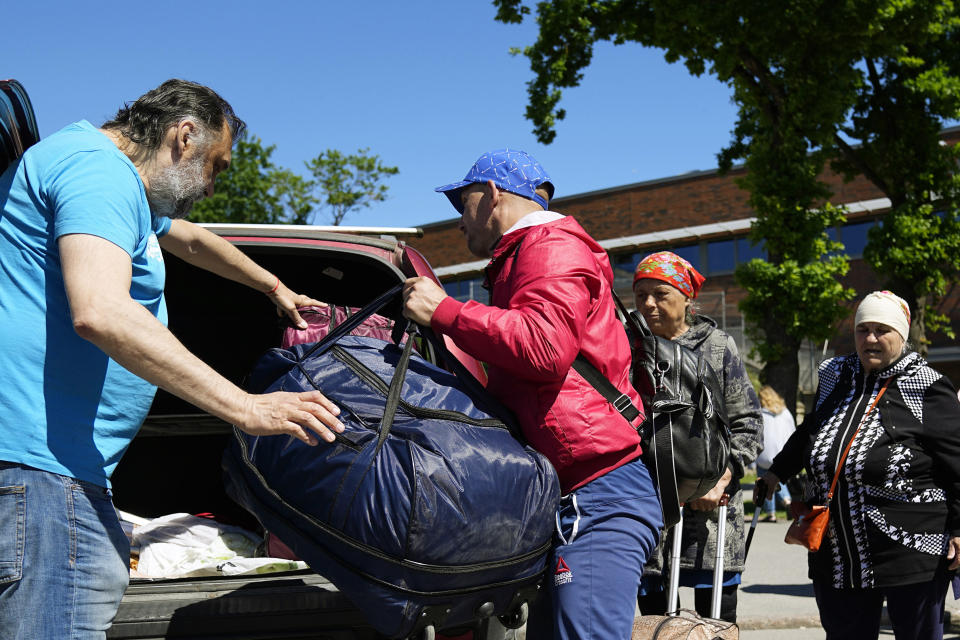 A family from Mariupol arrives in Estonia from Russia with the help of volunteers on both sides of the border in Narva, Estonia, Thursday, June 16, 2022. A clandestine network which includes Russian volunteers transports Ukrainians out of Russia, with them ending up as far away as Norway, Ireland, Germany and Georgia. (AP Photo)