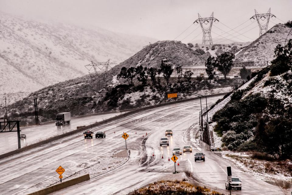 Vehicles were diverted off the northbound 15 Freeway to Kenwood Ave. on-ramp as Cajon Pass is shut down due to heavy snowfall in San Bernardino, Calif., on Dec. 26, 2019.