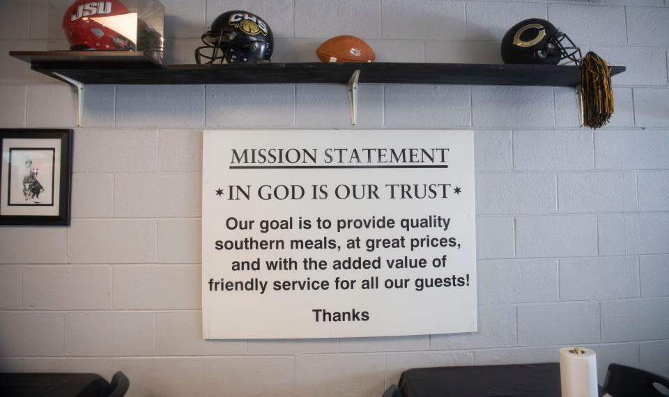 The Dallas' Place mission statement hangs on the wall under a display of local football helmets in Crossville, Alabama, Thursday, Nov. 3, 2022.