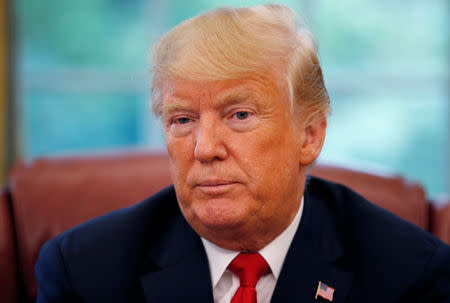 U.S. President Donald Trump listens to a question during an interview with Reuters in the Oval Office of the White House in Washington, U.S. August 20, 2018. REUTERS/Leah Millis