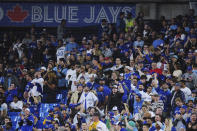 Fans watch as the Seattle Mariners take on the Toronto Blue Jays during the ninth inning of Game 1 of a baseball AL wild-card series, Friday, Oct. 7, 2022, in Toronto. (Nathan Denette/The Canadian Press via AP)