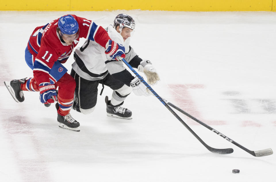 Montreal Canadiens' Brendan Gallagher (11) and Los Angeles Kings' Blake Lizotte (46) vie for the puck during the third period of an NHL hockey game Thursday, Dec. 7, 2023, in Montreal. (Christinne Muschi/The Canadian Press via AP)