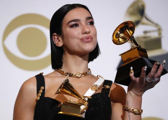 Dua Lipa poses backstage with her Grammys (Reuters)