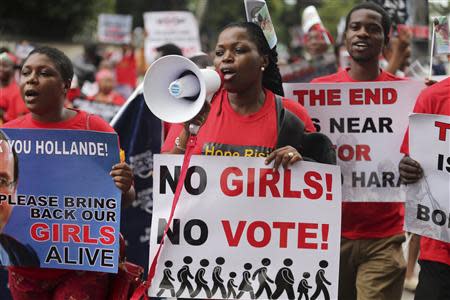 People hold placards calling for the release of secondary school girls abducted in the remote village of Chibok, during a protest along a road in Lagos May 14, 2014. REUTERS/Akintunde Akinleye