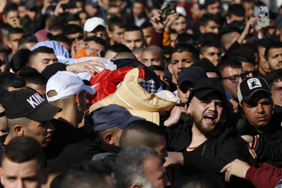 Palestinians carry the body of Yazan Abu Tabekh during his funeral in the West Bank city of Jenin, Thursday, Feb. 6, 2020. The 19-year-old Palestinian was killed in clashes with Israeli troops, according to Palestinian hospital officials. (AP Photo/Majdi Mohammed)