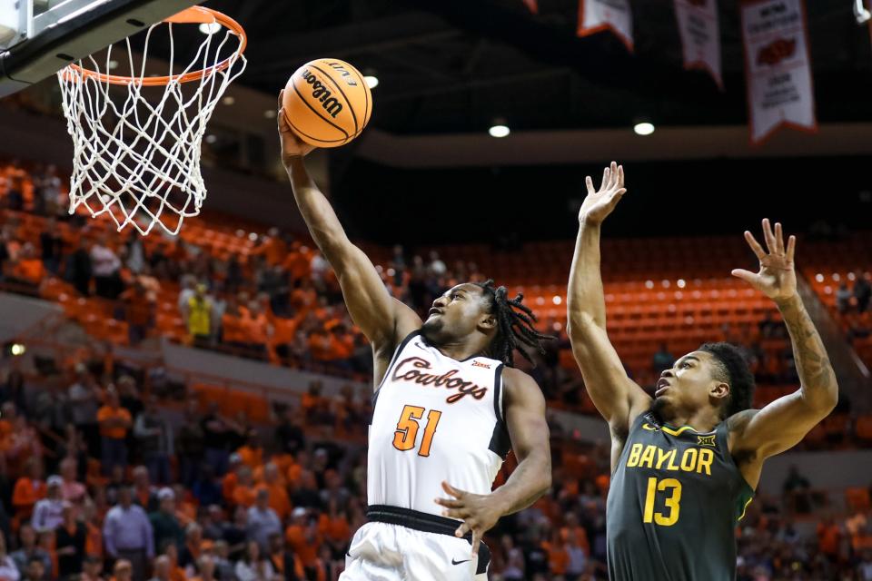 Oklahoma State guard John-Michael Wright (51) jumps past Baylor guard Keyonte George (1) to shoot for two in the first half during a college basketball game between the Oklahoma State Cowboys (OSU) and the Baylor Bears at Gallagher-Iba Arena in Stillwater, Okla., Monday, Feb. 27, 2023.