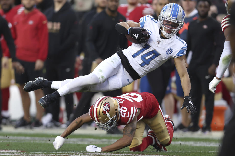 Detroit Lions wide receiver Amon-Ra St. Brown (14) tries to jump over San Francisco 49ers cornerback Ambry Thomas (20) during the first half of the NFC Championship NFL football game in Santa Clara, Calif., Sunday, Jan. 28, 2024. (AP Photo/Jed Jacobsohn)